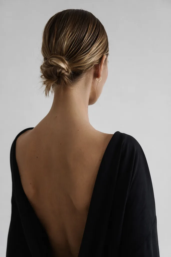 Our model from behind on the seamless backdrop, testing looks